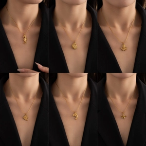 Golden stainless steel sea animal pendant necklaces featuring seahorse and octopus motifs