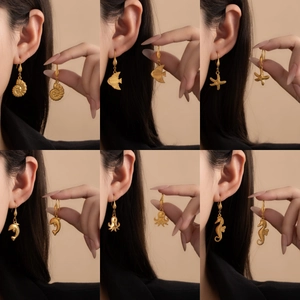 Ocean-themed gold titanium steel earrings set featuring starfish and seahorse motifs
