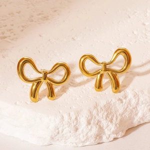 Polished gold stainless steel bow earrings set on white natural stone for women