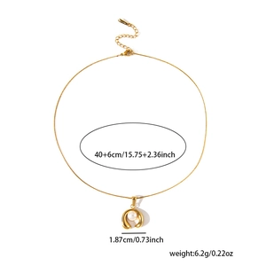 Detail of 18K gold plated horseshoe pendant necklace with pearl and lobster clasp
