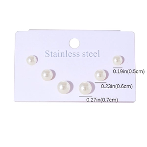 Detailed set of 3 sizes stainless steel faux pearl earrings on a purple display card