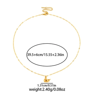 Detail view of a 18K gold whale pendant necklace showing precise measurements and weight