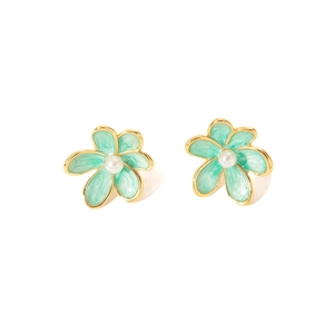 Detail of mint green enamel flower earrings with central white pearl and gold metal edges