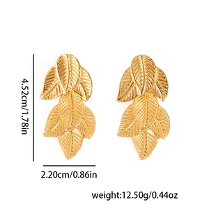 Detailed view of layered golden leaf earrings with intricate textures and realistic veins