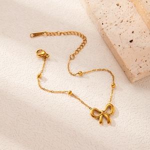Elegant gold stainless steel bow bracelet with delicate beads and adjustable lobster clasp