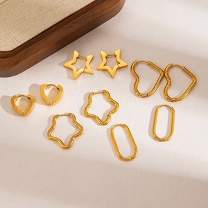Close-up of gold-plated stainless steel earrings featuring star, heart, and oval designs