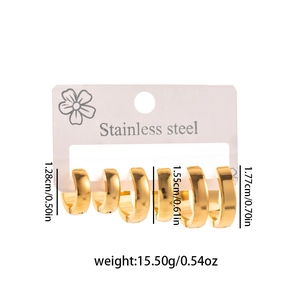 Three pairs of gold stainless steel hoop earrings in various sizes on white display card