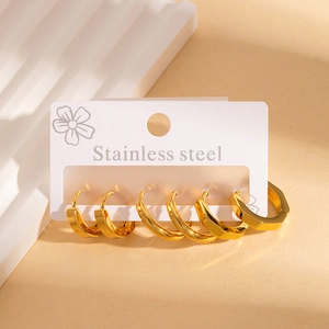 Three pairs of polished golden stainless steel earrings in round and hexagonal shapes