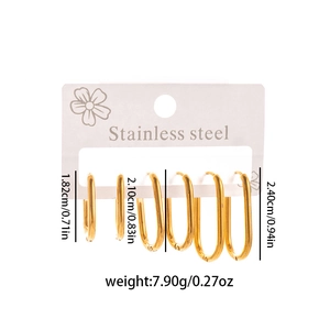 Three pairs of gold stainless steel oval hoop earrings in different sizes on display card