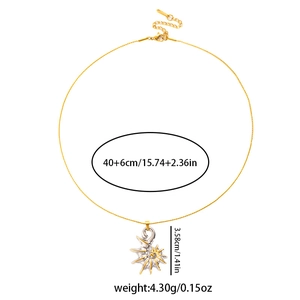 Detail shot of golden necklace with two-tone shell pendant and lobster clasp closure