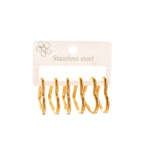 Three pairs of elegant gold heart-shaped stainless steel earrings on display card