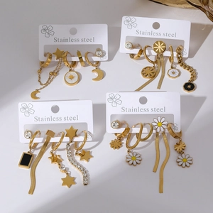 Golden stainless steel earring sets with heart and moon charms on white display cards