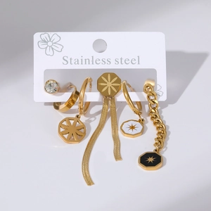 Close-up of gold stainless steel earrings set with sparkling cubic zirconia and star patterns