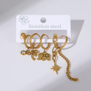Detail of gold stainless steel earrings set with butterfly, elephant and star charms
