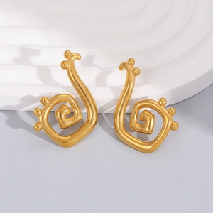 Minimalist gold spiral earrings with bead accents on modern pedestal display