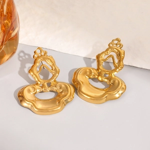 Vintage irregular golden stainless steel earrings with hollow crown design on artistic background