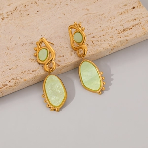 Detail of two-tone gold plated earrings with pale green shell texture on stone base