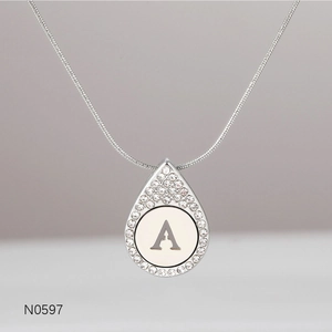 Detailed view of silver pendant necklace with letter A engraving and diamond accents