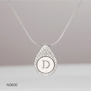 Detailed view of silver teardrop pendant with letter D and sparkling rhinestone halo