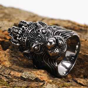 Macro shot of a vintage punk lion head ring with crown detailing on a rustic wood surface