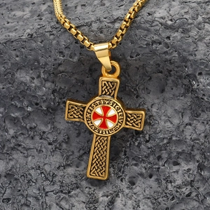Punk style gold titanium cross necklace with Knights Templar seal on a rugged rock background