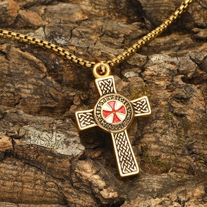 Gold Templar cross pendant necklace with Celtic knot patterns on a rustic bark background