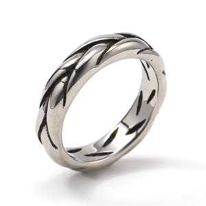 Macro view of woven braided texture on retro style stainless steel cross ring