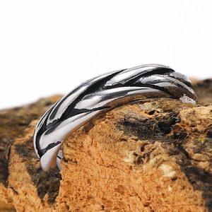 Close-up of industrial woven texture and retro black finish on stainless steel ring