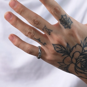 Detailed view of silver woven braid design stainless steel ring on model hand