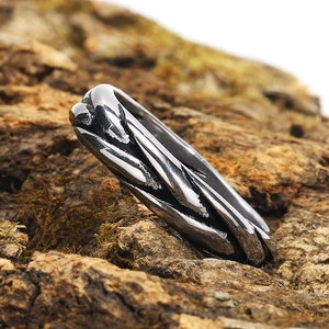Detail of twisted woven texture on vintage stainless steel ring set on a natural rock