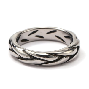 Macro shot of twisted woven texture on vintage stainless steel ring for men