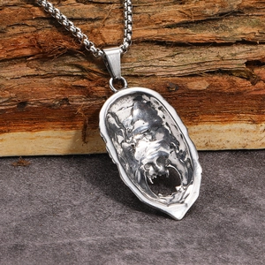Macro detail of the hollowed back design and vintage finish on Monkey King pendant