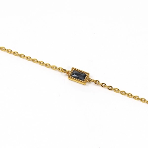 Minimalist stainless steel necklace featuring a rectangular black gemstone pendant with gold beads