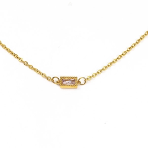 Detail of gold chain necklace featuring a rectangular pink zircon pendant with beaded edges