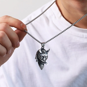 Retro hip hop bull demon pendant in stainless steel on male model wearing a white shirt