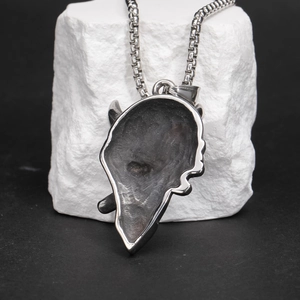 Gothic skull pendant showing the textured back and oxidized silver finish on a box chain