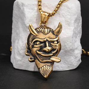 Close-up of vintage gold bull demon pendant with punk gothic textures on stone