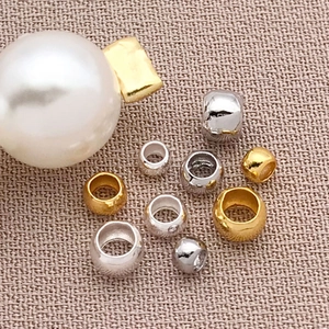 DIY jewelry kit with 18K gold and silver plated metal spacer beads on textured fabric