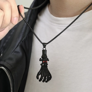 Punk skeleton hand pendant with red rhinestone eyes on a black chain necklace