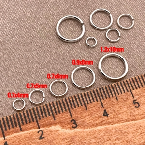 Macro view of 18k gold plated jewelry jump rings shown with ruler for size measurement
