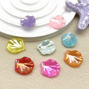 Detail of shell-shaped acrylic beads with pearlescent finish for DIY jewelry crafts