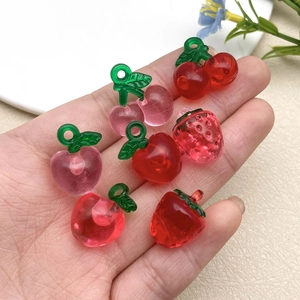 Macro shot of 3D resin fruit charms including strawberry and cherry for DIY jewelry making