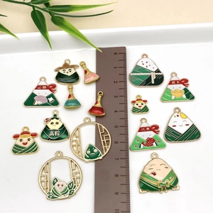 Detailed flat lay of enamel Dragon Boat Festival charms with lucky Chinese characters