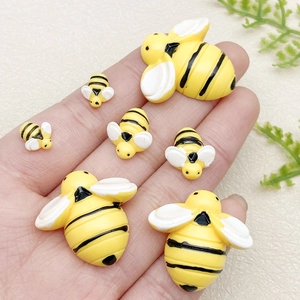 Trois tailles de breloques abeilles en résine pour le bricolage, présentées en main