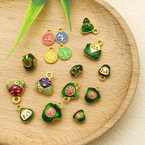 Detailed close-up of cartoon zongzi pendants with enamel finish and festive Chinese characters