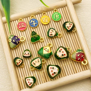 Detail of colorful enamel dragon boat festival charms on a traditional bamboo tray