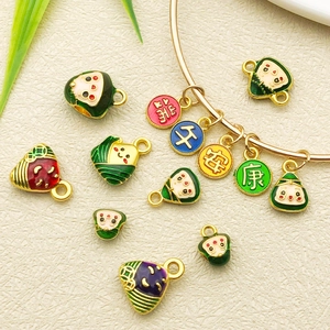 Handmade DIY jewelry charms kit featuring colorful enamel Zongzi and Daruma pendants