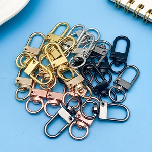 Top view of colorful swivel lobster clasps in five metal finishes on blue background