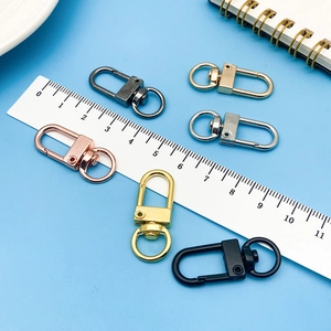 Macro shot of 32mm colorful alloy swivel lobster clasps with a ruler for size reference