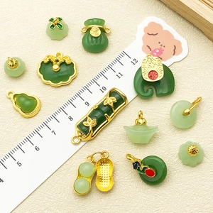 Detailed view of Chinese green glaze pendants with golden inlay for DIY jewelry making